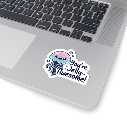 Laptop with a sticker of a jellyfish and text 'You're Jelly Awesome!' on a white surface.