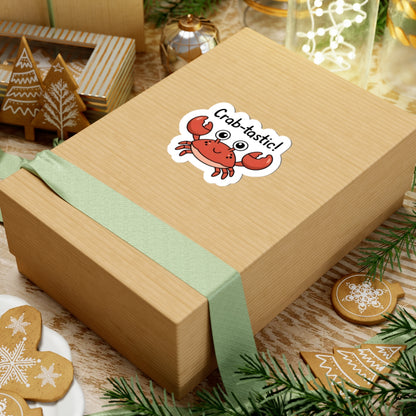 Wooden gift box with a crab-themed sticker on a festive background with cookies and greenery.