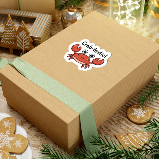 Wooden gift box with a crab-themed sticker on a festive background with cookies and greenery.